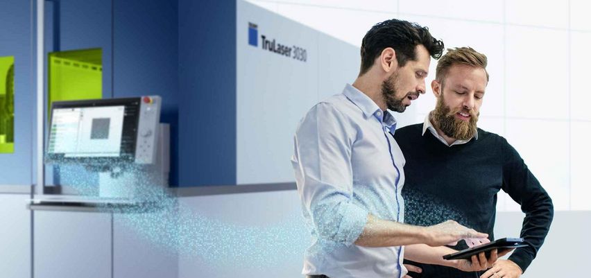 Condition Monitoring, two men looking at a tablet in front of a machine